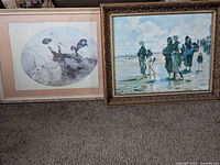Both framed artworks standing on carpet