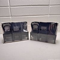 Front view of two sealed IKEA FJANTIG wall hook sets