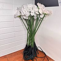 Bundle of LED rose stems with wiring and black stakes visible