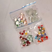 Four zip bags containing assorted miniature glass animals