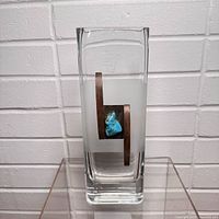 Front view of rectangular glass vase showing frosted band, wood strip and turquoise accent
