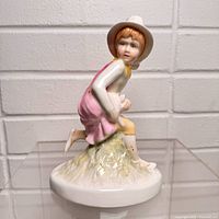 Front view of porcelain boy figurine on base