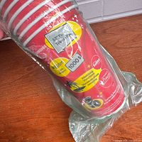 Close-up of top section of stacked red Tim Hortons Roll Up the Rim cups inside sealed plastic