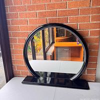 Front view of circular mirror on base