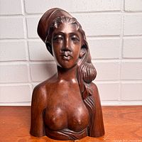Front view of carved Balinese woman bust