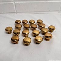All 18 brass knobs front view
