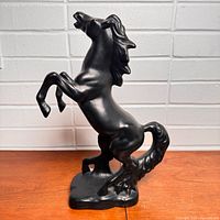 Front view of black ceramic rearing horse figure