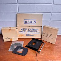 Overall lot with three Bogen boxes, loose carrier frame, mask insert and ring