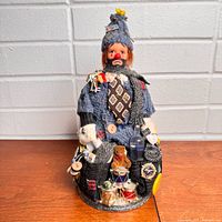 Full view of fabric hobo clown figure standing on base
