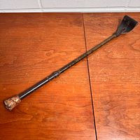 Full view of riding crop showing entire length, handle and flapper