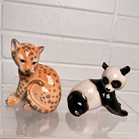 Front/side view of leopard and panda figurines