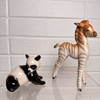 Front view of panda and giraffe figurines showing overall appearance