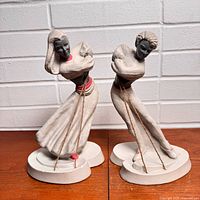 Front view of both chalkware dancer figurines