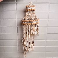 Full view of hanging sea shell wind chime showing size and cascading design