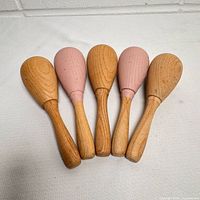 Front view of all five wooden sock darners in a row