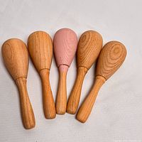 Five wood sock darners side-by-side showing finishes and size