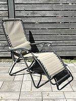 Front left angle of grey fabric folding reclining lounge chair