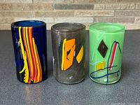 Front view of all three signed Kai Koppel tumblers