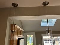 Both pendant lights hanging from ceiling showing full view and canopies