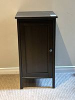 Front view of dark espresso cabinet showing door and knob