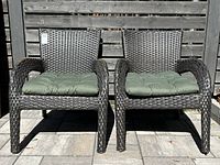 Front view of both resin wicker chairs with cushions