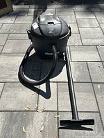 Front angled view of Shop-Vac with hose and wand attached