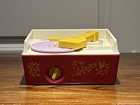 Front view showing red base, purple turntable, yellow tone arm