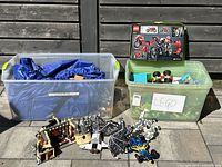 Overall lot: two totes, box on right tote, built models in front