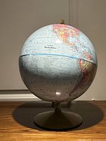 Front view of Replogle World Nation globe on base