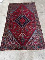 Full view of hand-knotted Persian geometric rug showing overall design and size