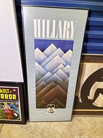 Full view of framed hand-signed Sir Edmund Hillary Foundation poster with mountain graphic and portrait inset