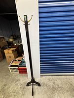 Full view of the wood coat rack showing post, hooks, and base