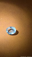 Front view of oval aquamarine showing blue color and faceting