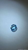 Top view of single oval cabochon Swiss blue topaz