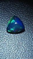 Trillion cabochon opal showing green and blue flashes