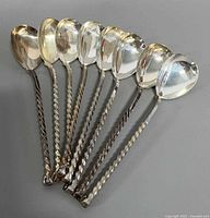 All eight twist-handle melchior teaspoons aligned
