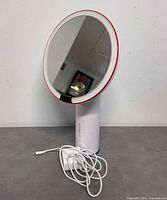 Front view of AMIRO smart makeup mirror on stand with power adapter and cord