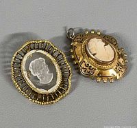Both cameo pieces front view showing design and size relation