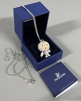 Necklace, pendant, box and certificate booklet displayed