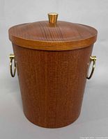 Front view of teak ice bucket with lid and brass handles