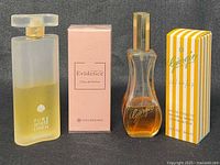 Front view of three perfumes: Estee Lauder bottle, sealed Yves Rocher box, Giorgio Beverly Hills bottle and box
