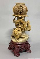 Front view showing openwork globe, foo dogs, lotus base, and stand