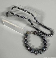 Necklace and bracelet overview on stand