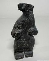 Front view of upright stone bear sculpture