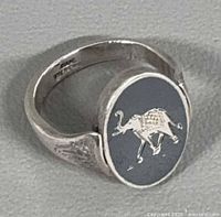 Ring side view showing niello elephant design and engraved shoulder