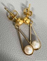 Front view of both earrings showing overall design, gold tone and pearls