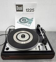 Top view of Dual 1225 turntable with manual displayed