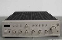 Three-quarter view of Harman Kardon PM655 VXi amplifier showing top and front panels