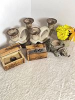 Group shot of all items including three ceramic candle holders, two wooden boxes, elephant holder, bud vase with flowers