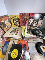 Stacks of LPs and 45s with visible covers: Steve Earle, Jethro Tull, The Police, others